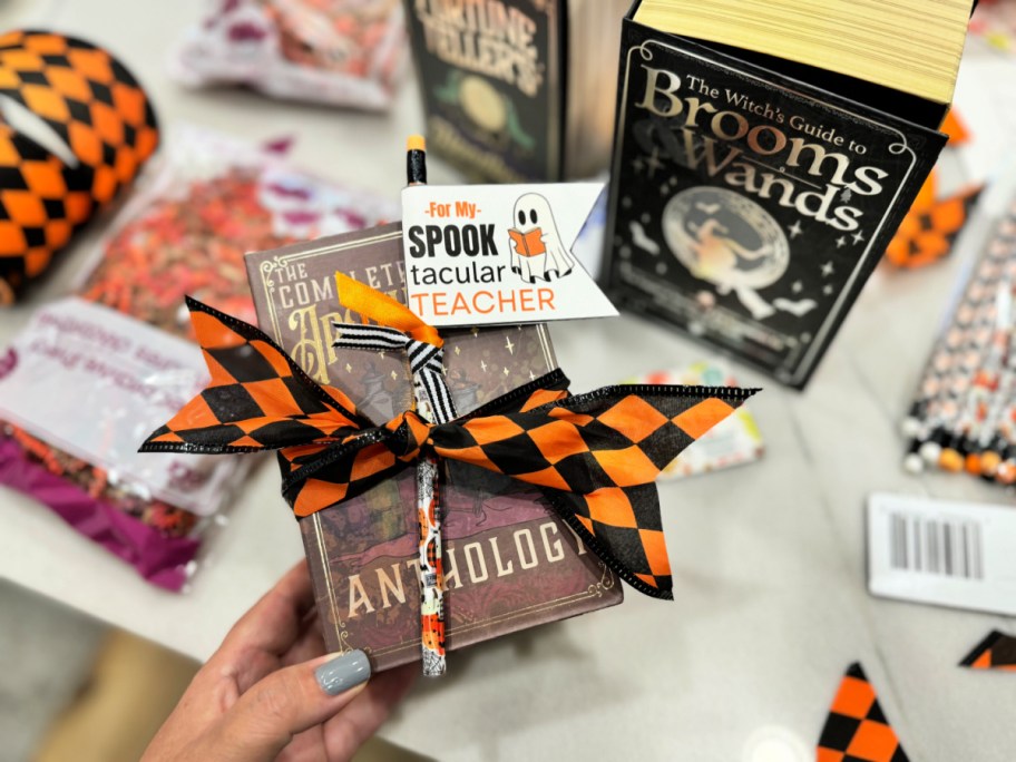 holding a spooktacular teacher book box gift 