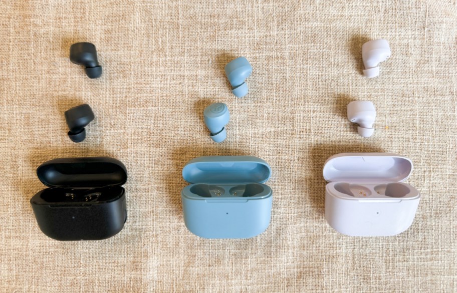 three sets of jlab earbuds displayed near their cases