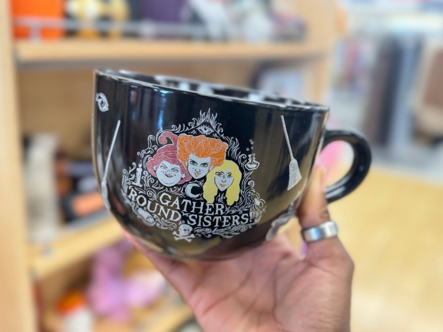 hand holding a Hocus Pocus mug