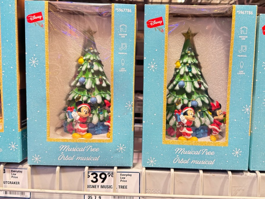 two disney musical christmas tree boxes on shelf