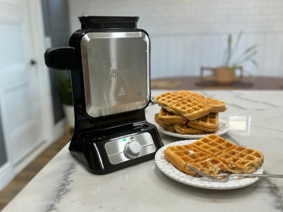 upright waffle maker next to waffles