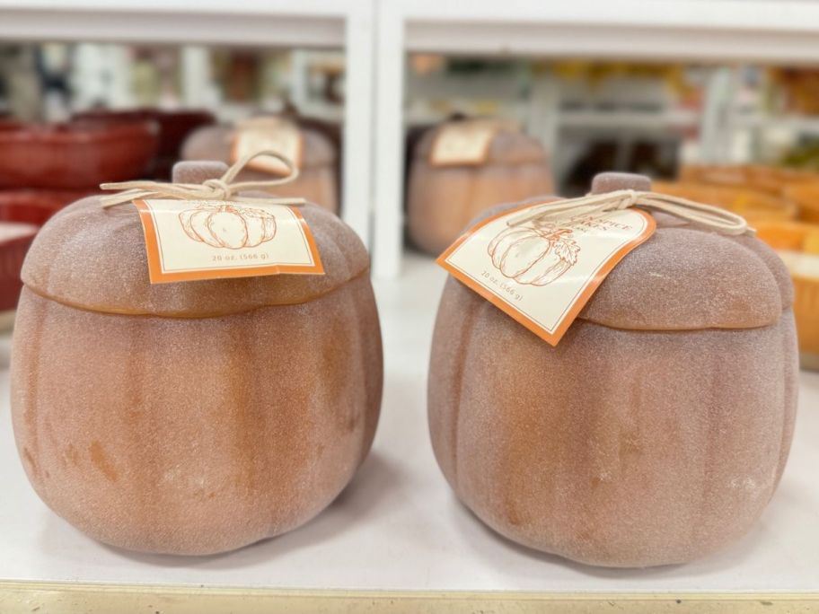 orange pumpkin candle sitting on shelf