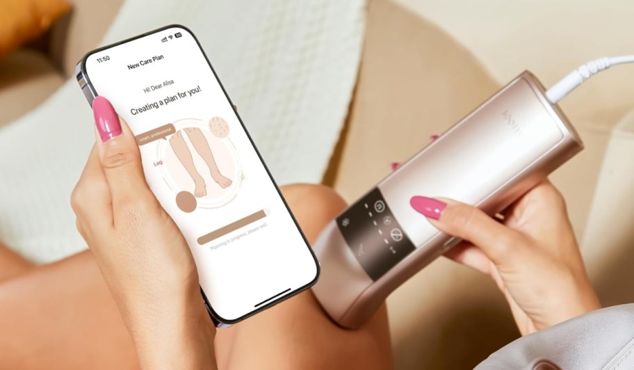 hand holding laser hair remover next to phone