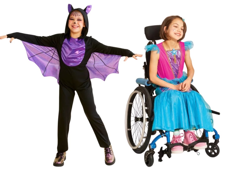 little girl wearing a black and purple bat costume and little girl in a wheelchair wearing a mermaid dress costume