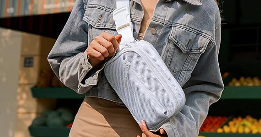 woman wearing white mesh belt bag with tan dress 