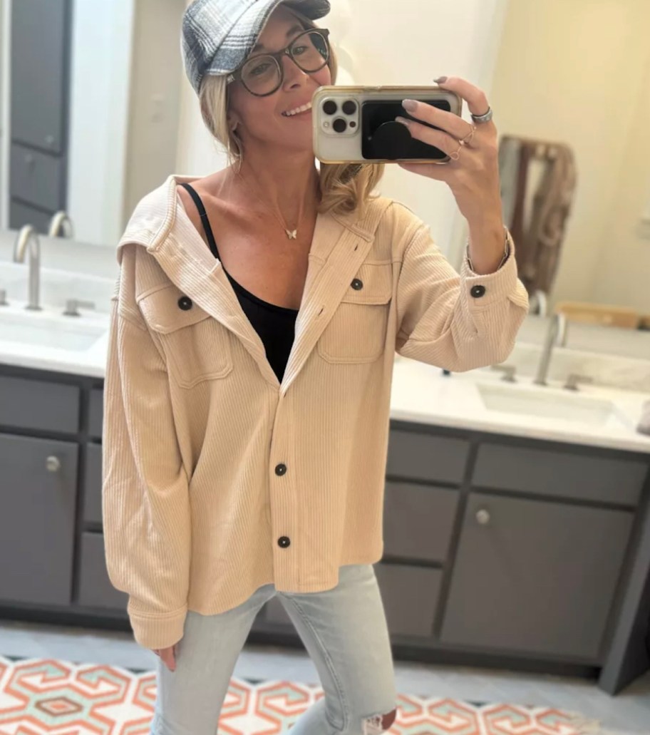 woman taking mirror selfie wearing beige shacket 