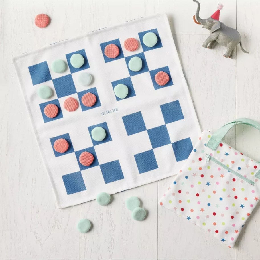 kids soft checkerboard toy set with a bag to hold the pieces in and a toy elephant next to it