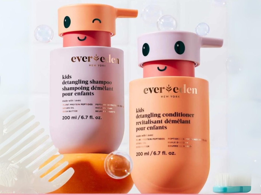 purple, peach, and pink bottles of Evereden Kids Hair Detangling Shampoo & Conditioner, bottles have smiley face on the pump part