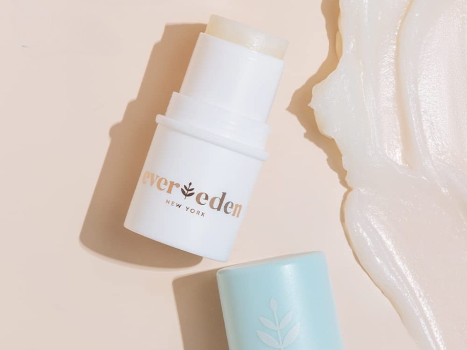 open tube and lid of an Evereden Baby Lip Balm with some spread to the side