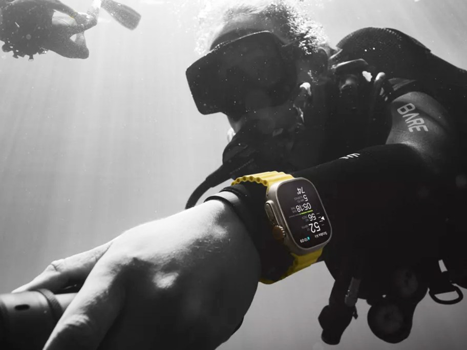 person wearing apple watch while scuba diving