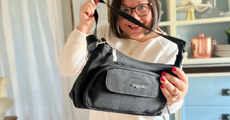 woman holding a black Baggallini Everyday Bagg