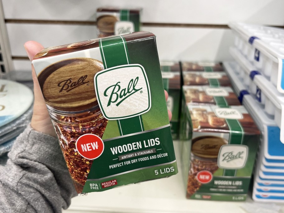 hand holding a box of Ball Wooden Storage Lids in store