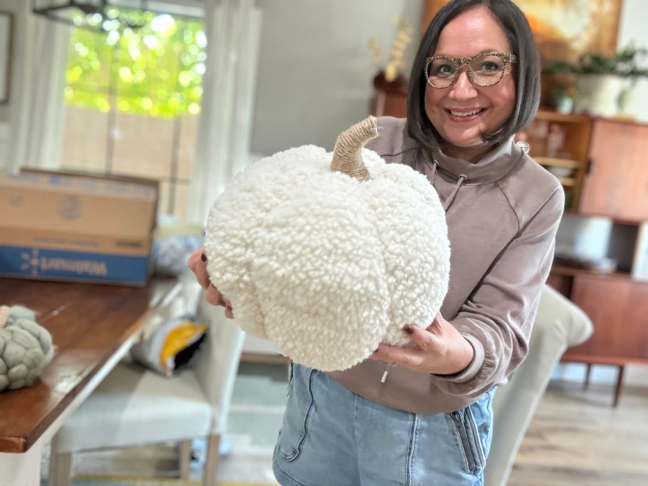 woman holding cream fabric pumpkin, one of our Walmart fall decor finds