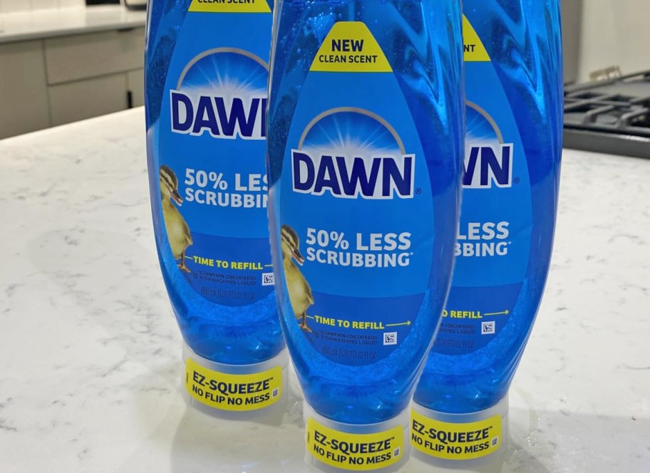 three blue bottles of Dawn EZ-Squeeze Dish Soap on kitchen counter