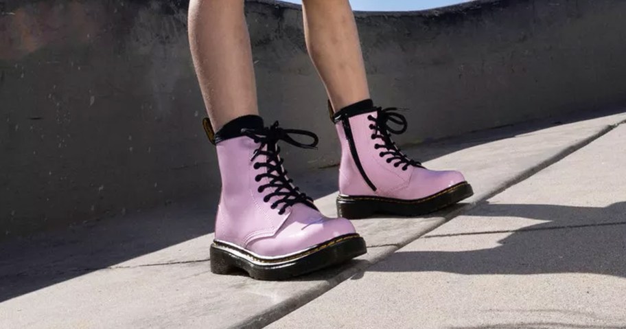 girl wearing pink and black boots