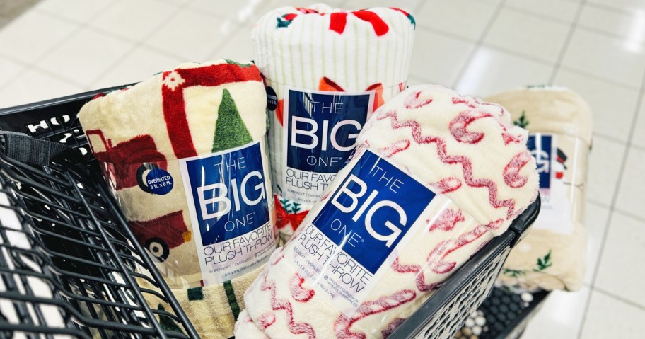 multiple christmas throw blankets in a shopping cart