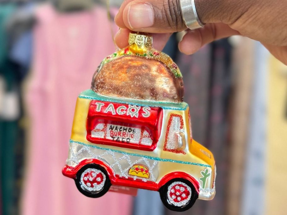 Hand holding up a St. Nicholas Square Glass Taco Truck Ornament