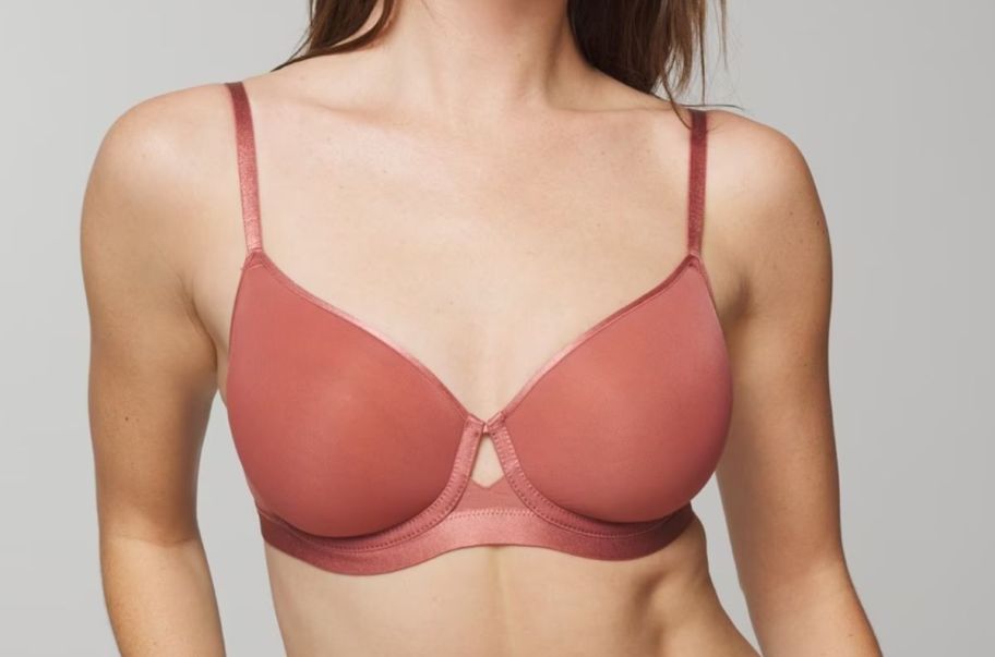 a model wearing a rose colored wired bra