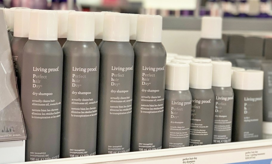 grey bottles of Living Proof Perfect Hair Day Dry Shampoos on store shelf