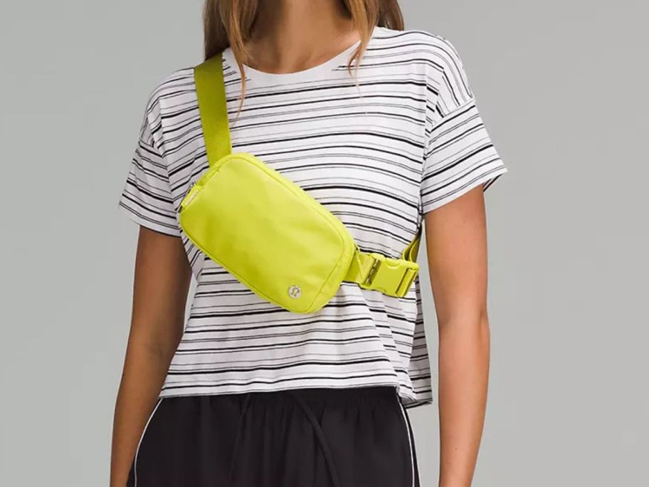 A woman wearing a lululemon Everywhere Belt Bag 1L in yellow