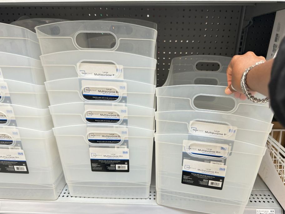 person grabbing Plastic Utility Storage Organizer Bin from store shelf