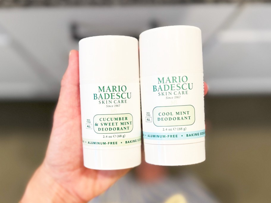 hand holding two sticks of Mario Badescu Aluminum Free Deodorants