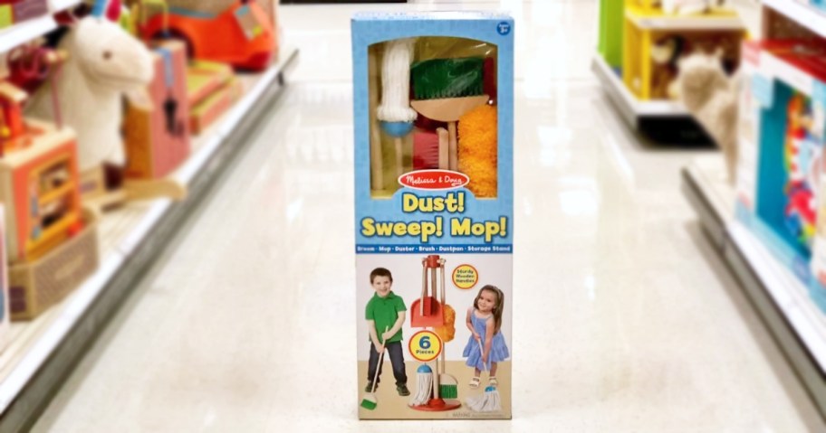 Melissa & Doug brand toy set with pretend duster, broom, and mop in package in store aisle