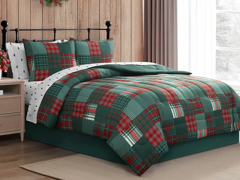 green and red patchwork comforter and shams on bed