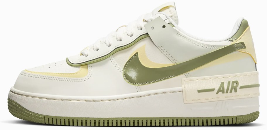 white, green, and light yellow nike sneaker
