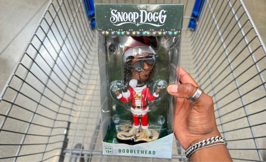 a eomans hand holding a snoop dogg bobble head