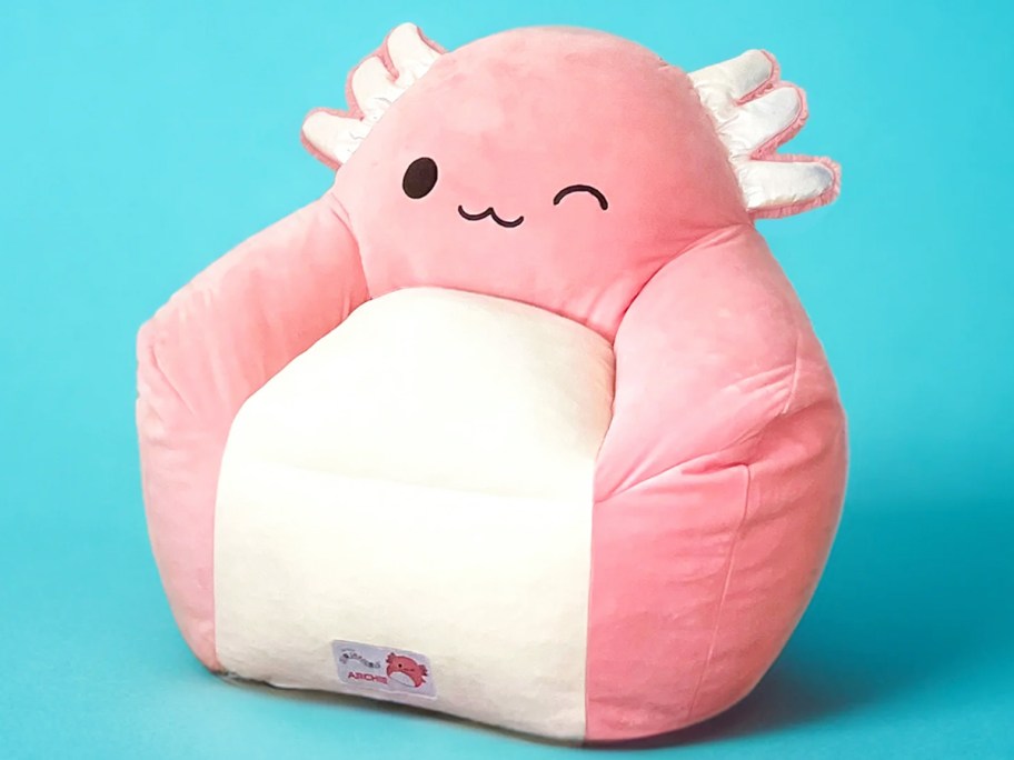 pink axolotl bean bag chair on blue background