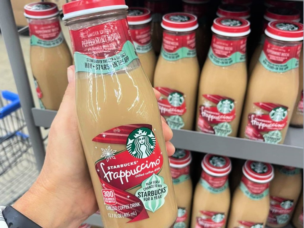 person holding up Starbucks Peppermint Mocha Frappuccino in walmart