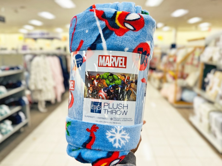 hand holding up a christmas spiderman print throw blanket