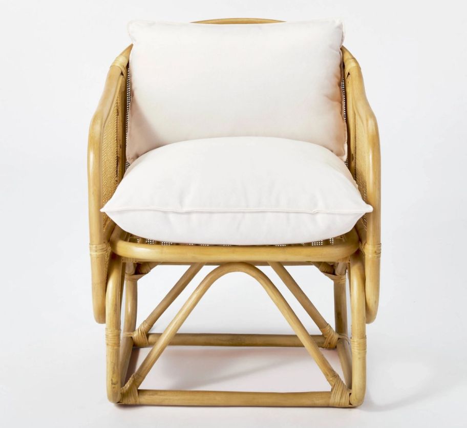 a natural colored wicker barrel back accent chair