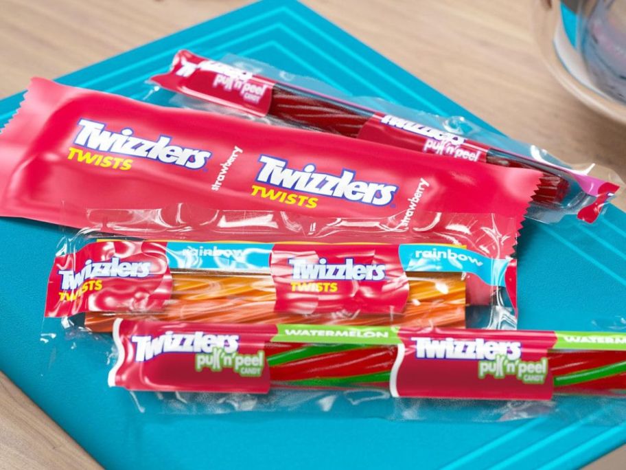 Assorted individually wrapped Twizzlers candy on a book