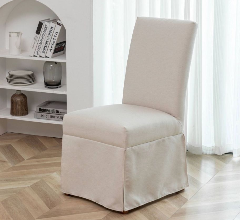 a cream-colored armless dining chair