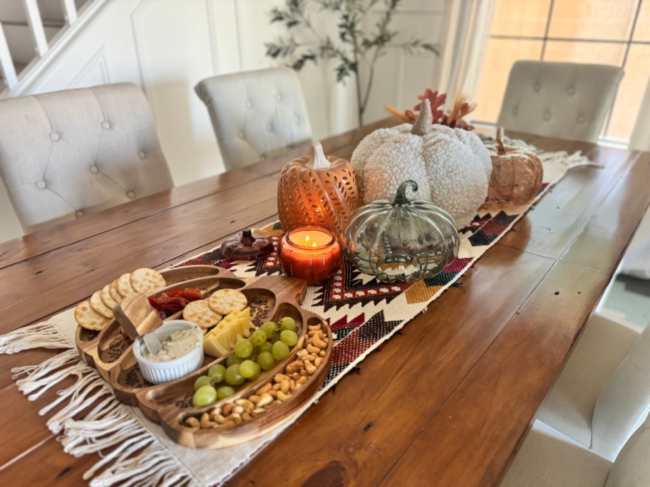 A dining table set with Walmart fall decor like pumpkins and a pumpkin tray