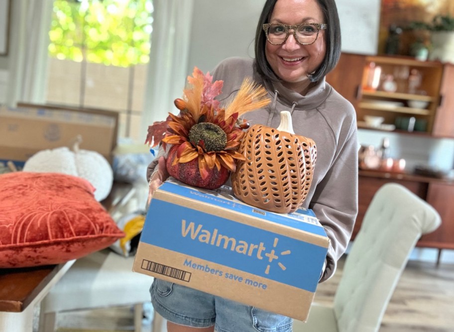 Women holding Walmart Fall Finds including pumpkin decor