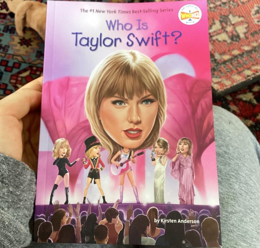 hand holding Who is Taylor Swift? book