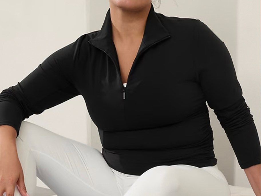 woman wearing black half zip jacket