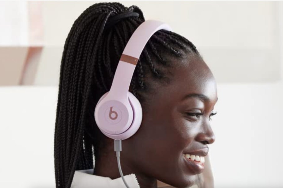 woman wearing pink headphones