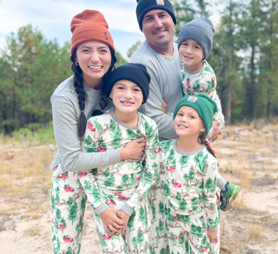 family of 5 outside in matching christmas jammies