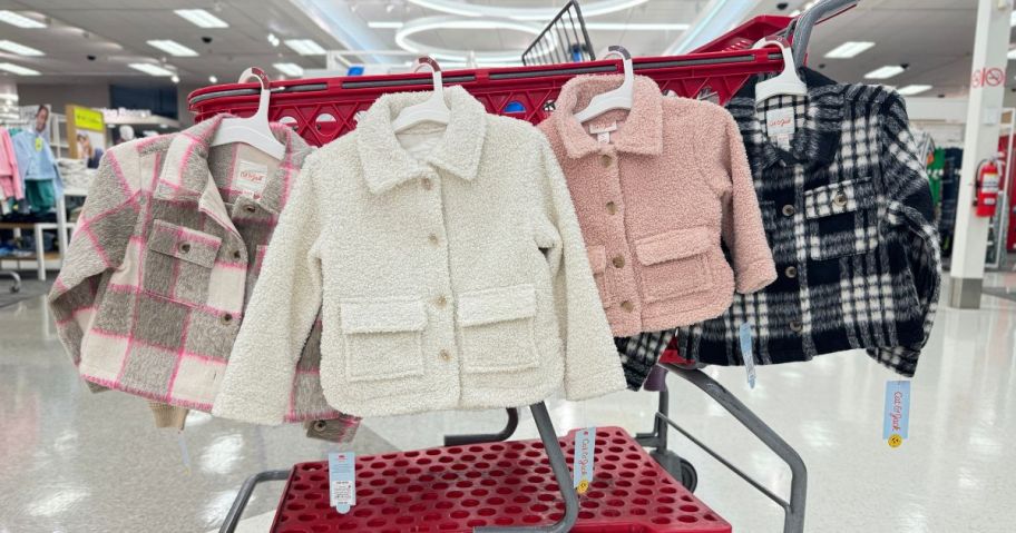 cat and jack girls shackets hanging on cart in store