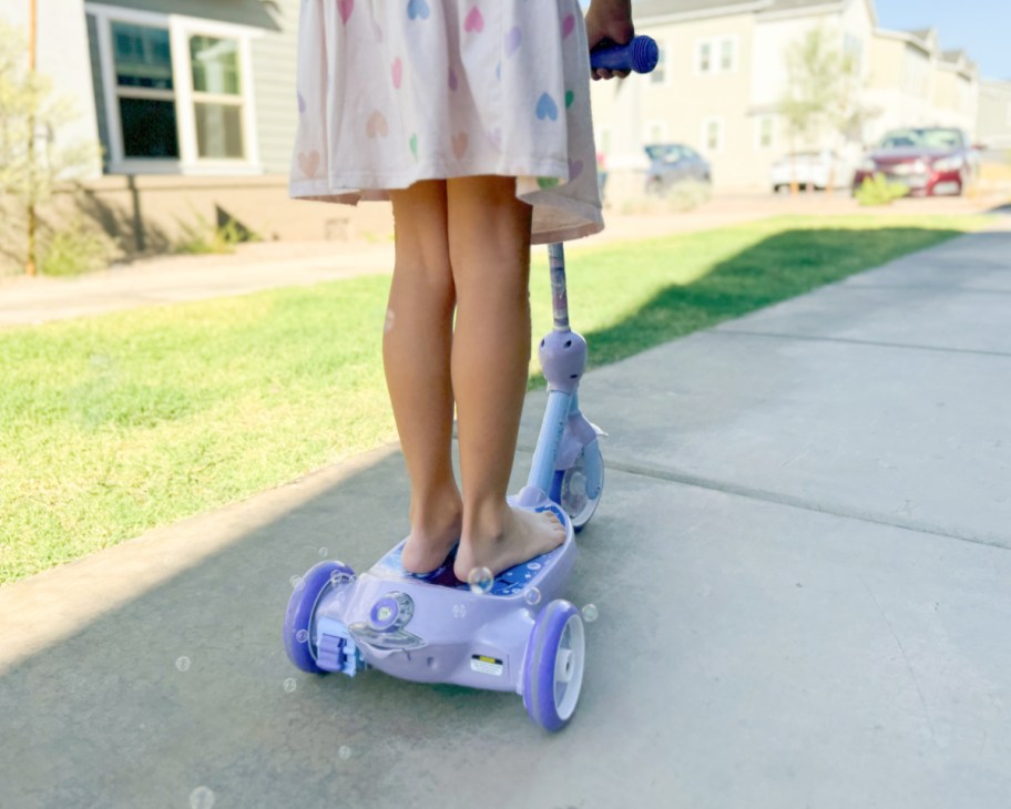 girl riding on frozen bubble scooter