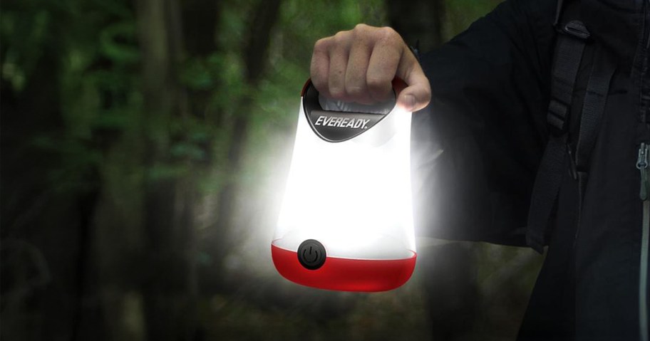 person holding a camping lantern