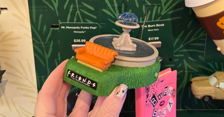 hand holding friends hallmark ornament 