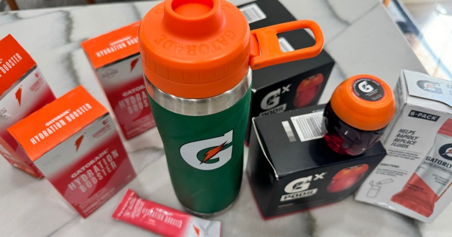 gatorade bottle surrounded by pods, tablets, and powders