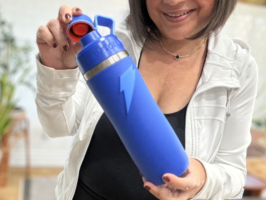 woman holding a blue stainless steel insulated Gatorade water bottle