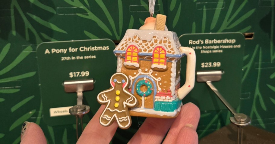 hand holding gingerbread house ornament