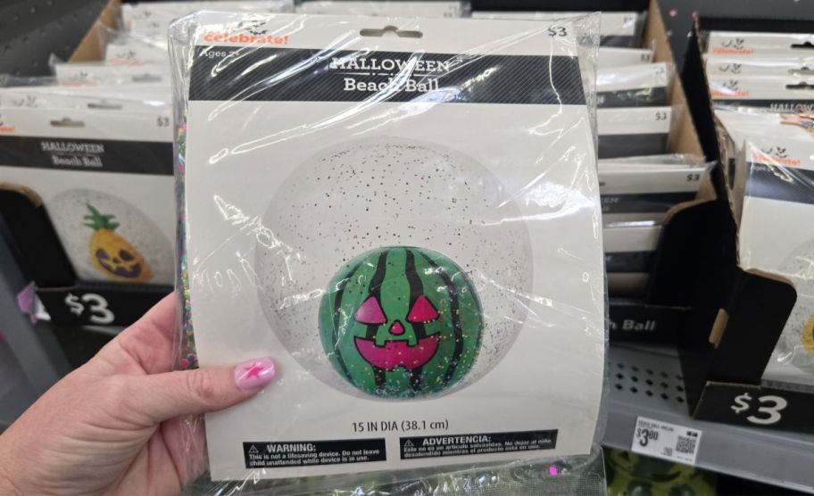a woman's hand holding a watermelon summerween beachball